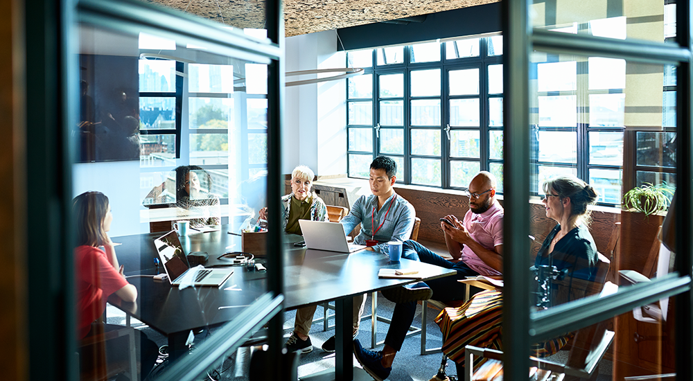 Businesswoman leading team meeting in coworking office